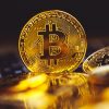 Ce este Bitcoin? Bitcoin coins on laptop keyboard. Cryptocurrency